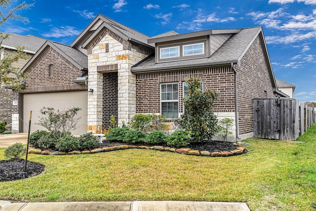 view of front property featuring a garage and a front yard