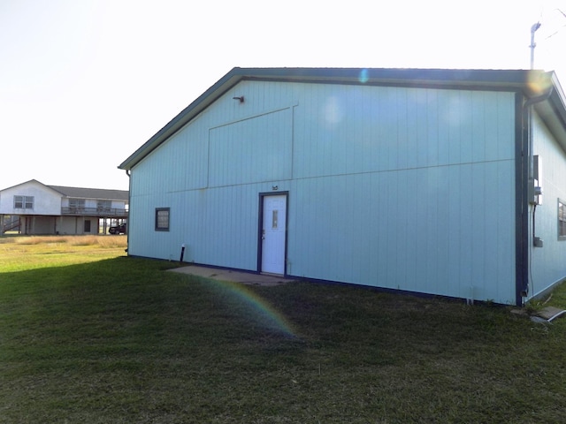 view of outbuilding featuring a yard