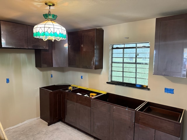 kitchen featuring dark brown cabinetry, electric panel, and hanging light fixtures