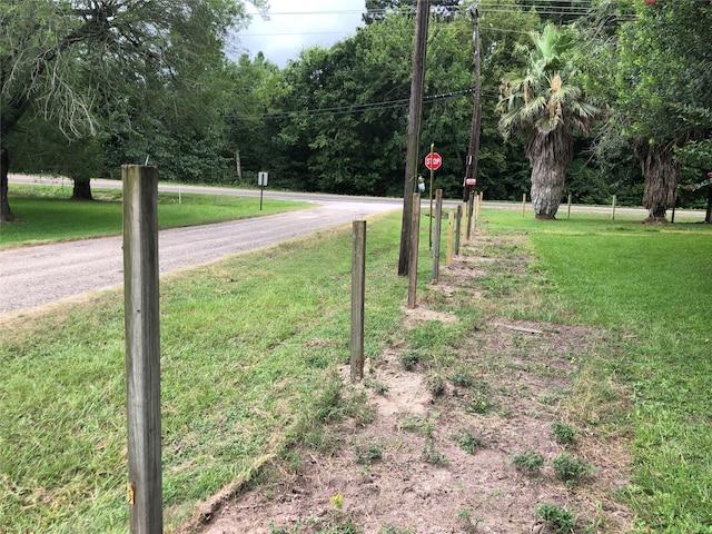 411 Lawrence Rd, Trinity, TX 75862 - view of road with traffic signs and a forest view