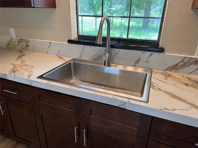 411 Lawrence Rd, Trinity, TX 75862 - kitchen view of dark brown cabinets, a textured wall, and light countertops