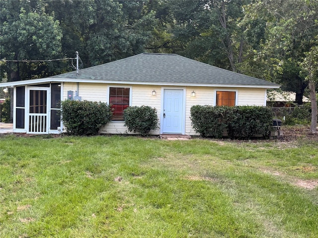 411 Lawrence Rd, Trinity, TX 75862 - bungalow with a shingled roof, a front lawn, and a sunroom