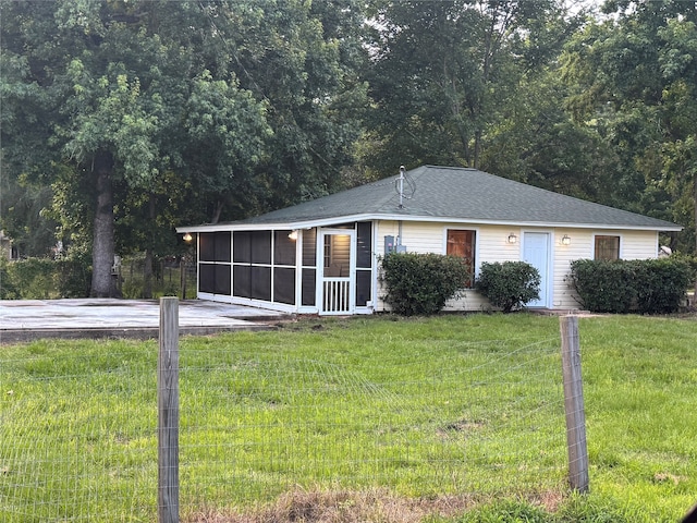 411 Lawrence Rd, Trinity, TX 75862 - view of front facade with a sunroom and a front yard