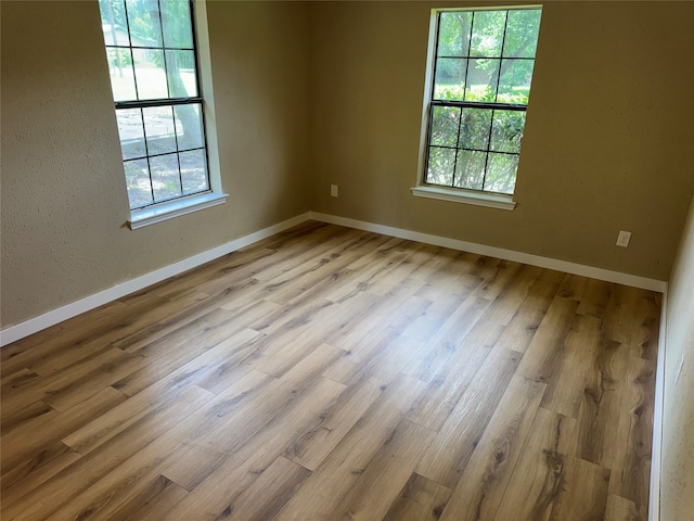 411 Lawrence Rd, Trinity, TX 75862 - unfurnished room featuring healthy amount of natural light and wood finished floors