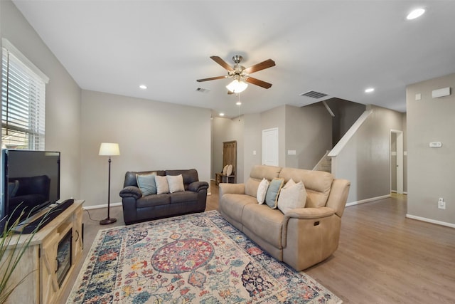 living room featuring ceiling fan and light hardwood / wood-style floors