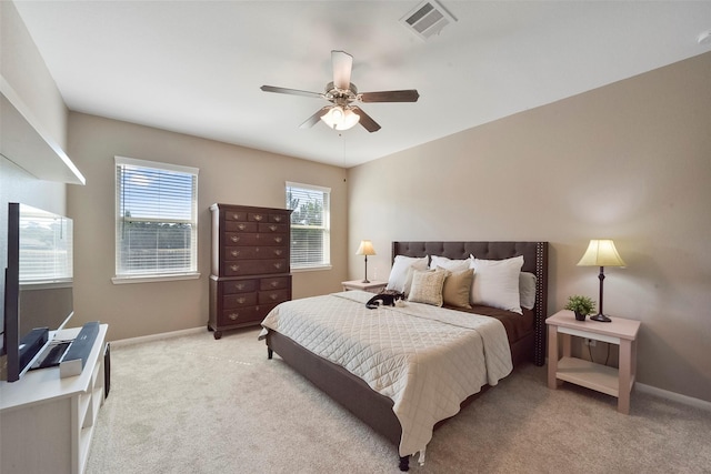 bedroom featuring ceiling fan and light carpet