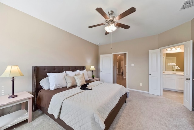 carpeted bedroom featuring ceiling fan and connected bathroom