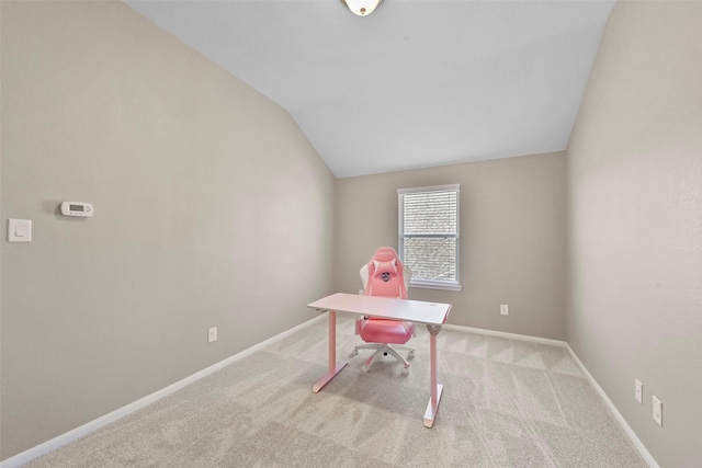 unfurnished office with light colored carpet and vaulted ceiling