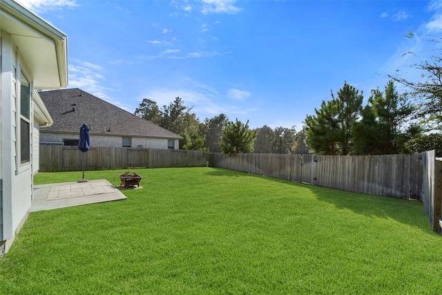 view of yard featuring a fire pit and a patio