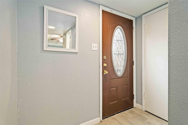 foyer featuring light hardwood / wood-style floors and ceiling fan