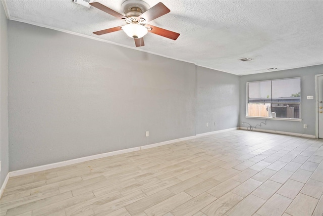 empty room with a textured ceiling, light wood-type flooring, and ceiling fan