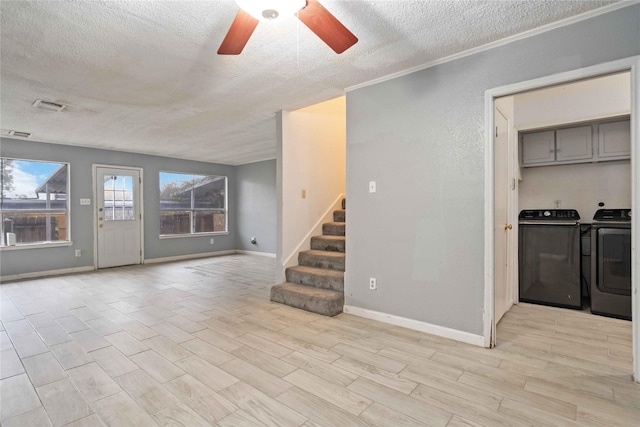 unfurnished living room featuring ceiling fan, light hardwood / wood-style flooring, a textured ceiling, washer and dryer, and ornamental molding