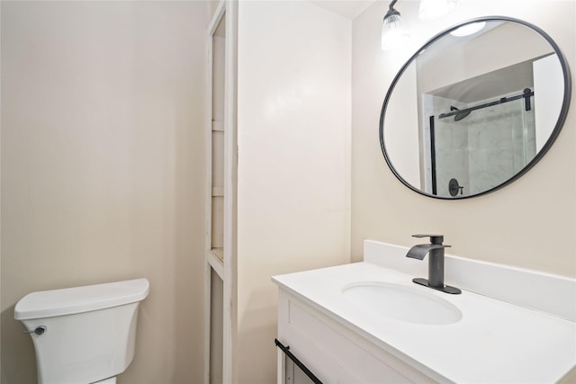 bathroom featuring vanity, toilet, and an enclosed shower