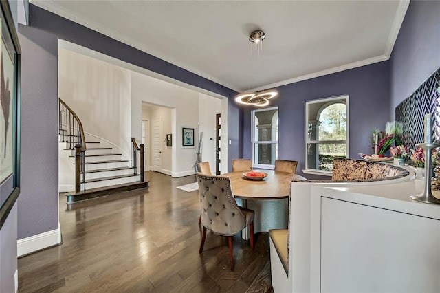 dining area with dark hardwood / wood-style floors and ornamental molding