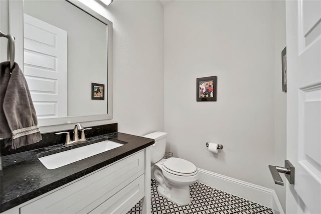 bathroom with tile patterned floors, vanity, and toilet