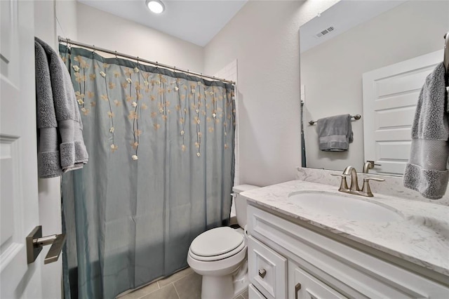 bathroom featuring tile patterned flooring, vanity, curtained shower, and toilet