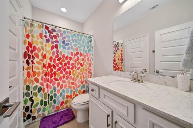 bathroom featuring tile patterned floors, vanity, and toilet