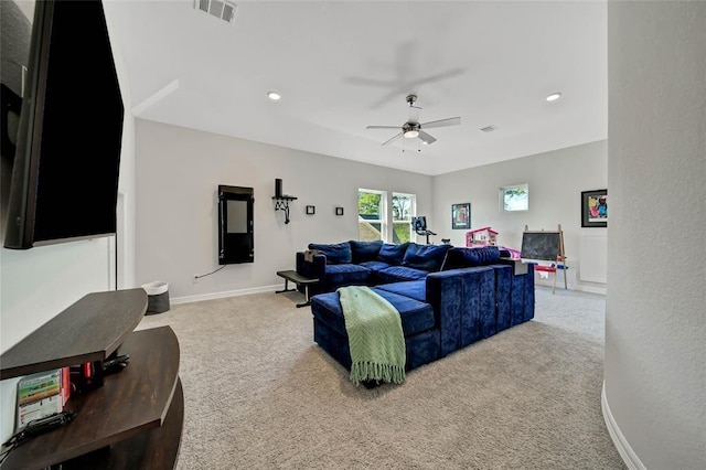 carpeted living room with ceiling fan