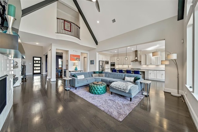 living room with high vaulted ceiling and dark hardwood / wood-style floors