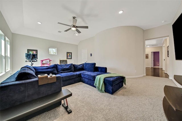 living room featuring ceiling fan, carpet floors, and vaulted ceiling