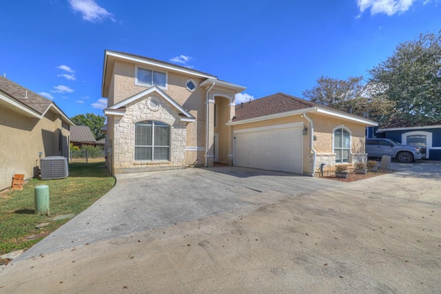 front of property with cooling unit and a garage