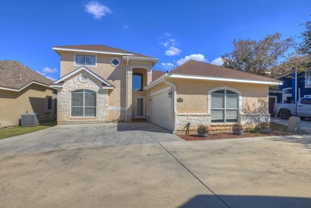 view of front of home featuring cooling unit and a garage