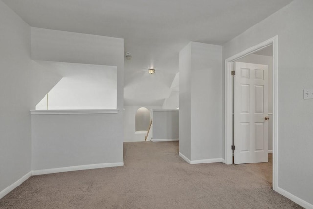 bonus room featuring light colored carpet