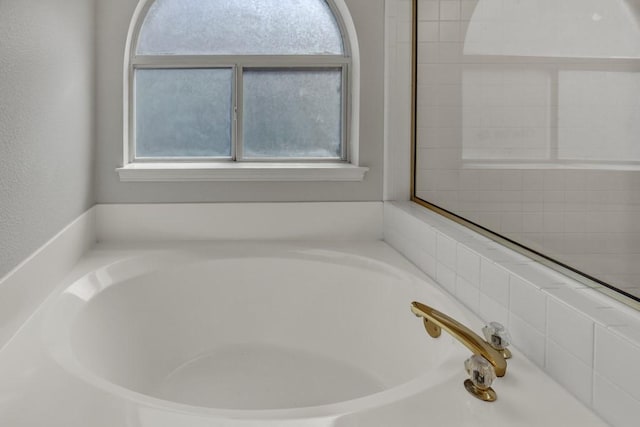 bathroom featuring tiled bath