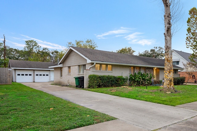 ranch-style house featuring a garage and a front lawn