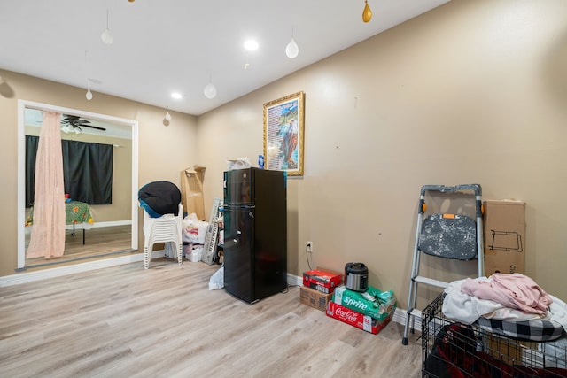 misc room featuring light wood-type flooring and ceiling fan