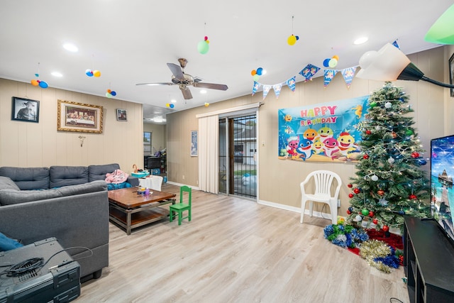 living room with ceiling fan and light hardwood / wood-style flooring