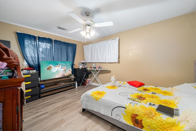 bedroom with ceiling fan and light wood-type flooring