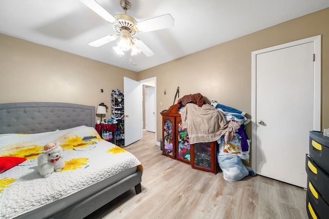 bedroom with light wood-type flooring and ceiling fan