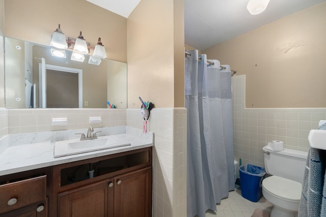 full bathroom with tile patterned flooring, shower / bath combination with curtain, toilet, vanity, and tile walls