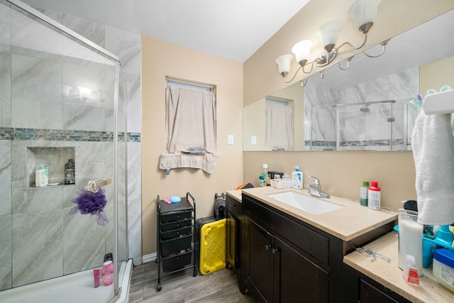 bathroom with vanity, hardwood / wood-style flooring, and walk in shower