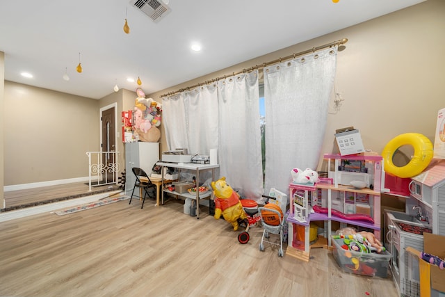 recreation room with light hardwood / wood-style flooring