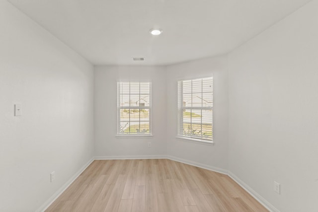 empty room with light hardwood / wood-style flooring