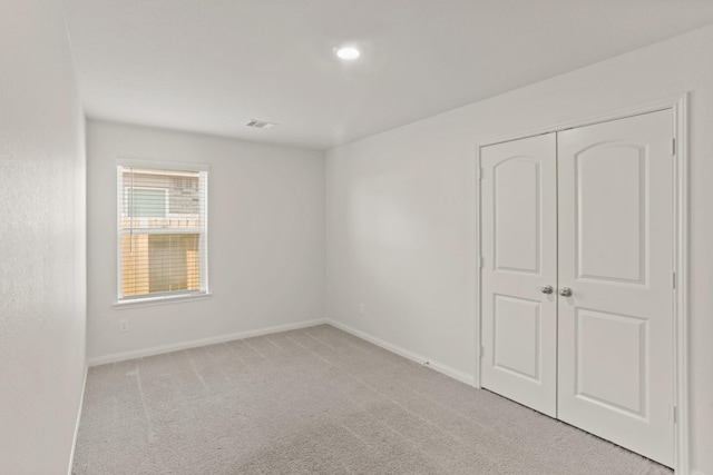 empty room featuring light colored carpet