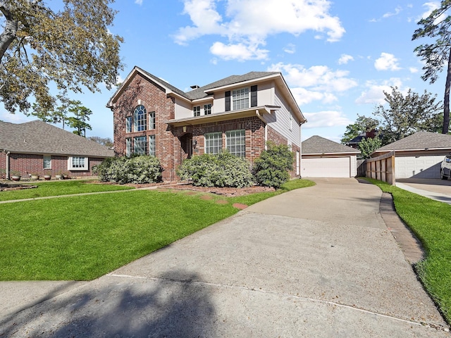 view of front property featuring a garage, an outbuilding, and a front lawn