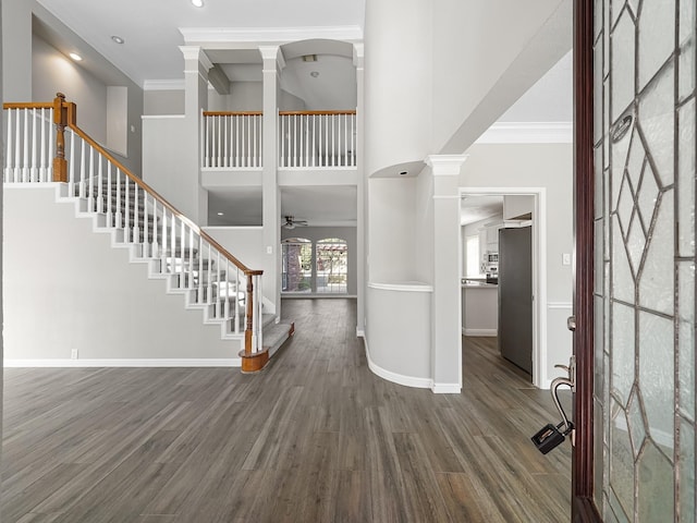 foyer entrance featuring crown molding, ceiling fan, and dark hardwood / wood-style floors