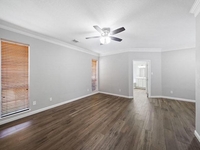 empty room with a healthy amount of sunlight, crown molding, ceiling fan, and dark wood-type flooring