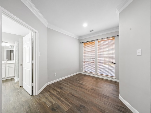 empty room with wood-type flooring, ornamental molding, and sink