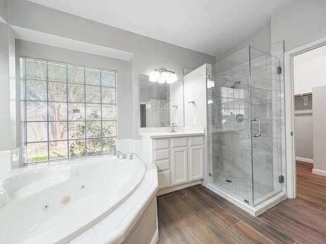 bathroom featuring separate shower and tub, hardwood / wood-style floors, and vanity