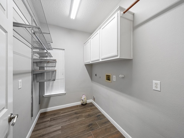 clothes washing area featuring gas dryer hookup, cabinets, hookup for a washing machine, hookup for an electric dryer, and dark hardwood / wood-style flooring