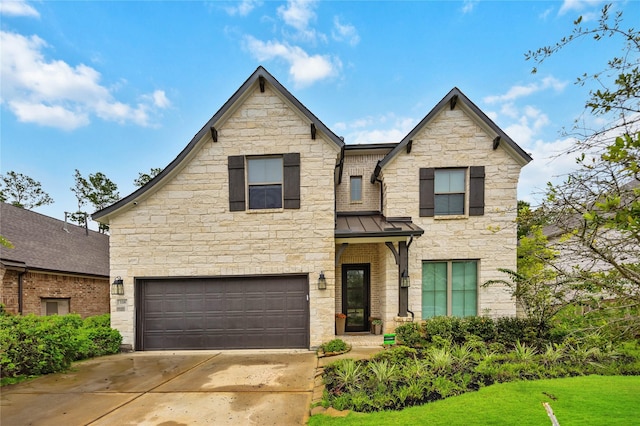 view of front of home featuring a front yard and a garage