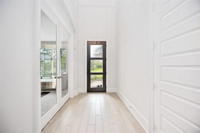 doorway to outside featuring french doors and light hardwood / wood-style flooring