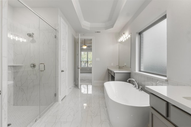 full bath with a tray ceiling, marble finish floor, a marble finish shower, a soaking tub, and visible vents