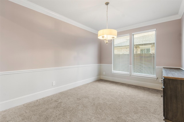 empty room featuring ornamental molding, carpet, and baseboards