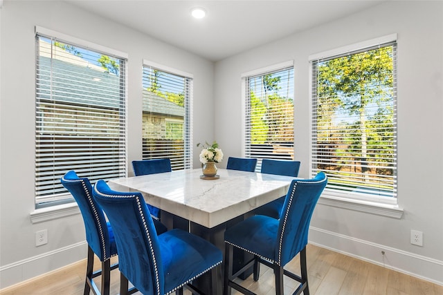 dining area featuring light wood-style flooring, baseboards, and recessed lighting