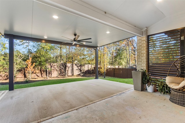 view of patio with ceiling fan and fence